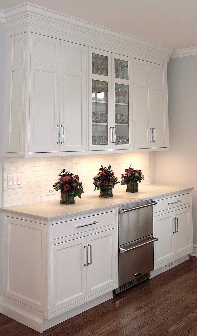 Kitchen Counter with Flowers and White Cabinets